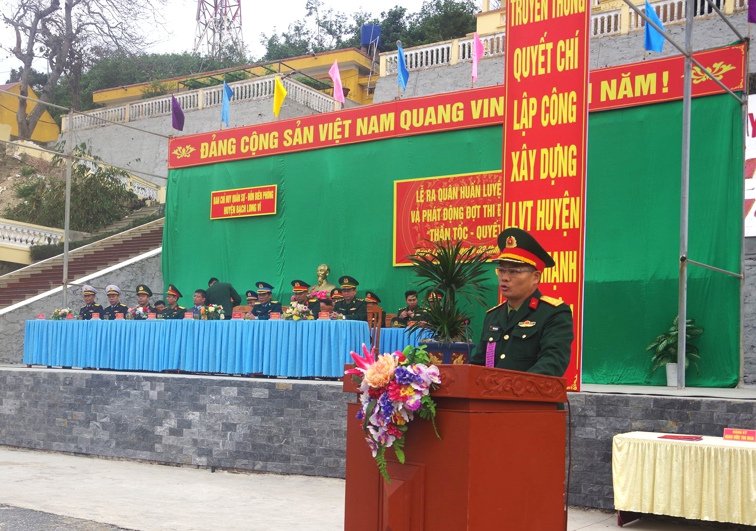 A person in uniform standing at a podium
Description automatically generated