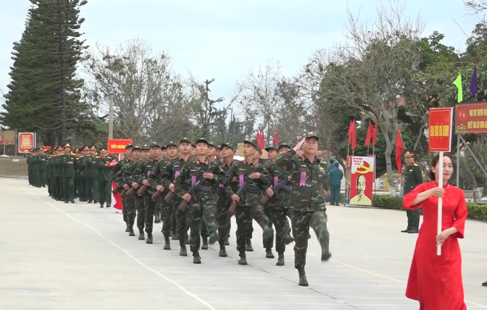 A group of soldiers marching on a street
Description automatically generated