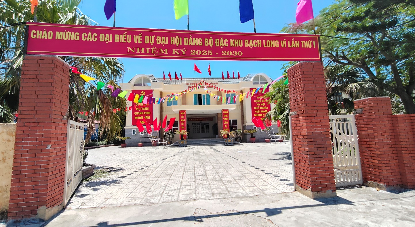 A building with a red sign and flags

Description automatically generated