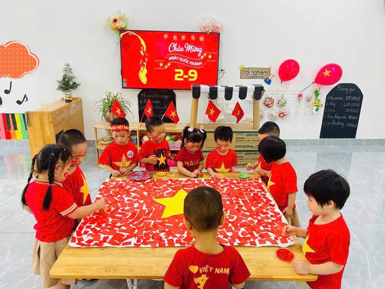 A group of children sitting around a table with a flag
AI-generated content may be incorrect.