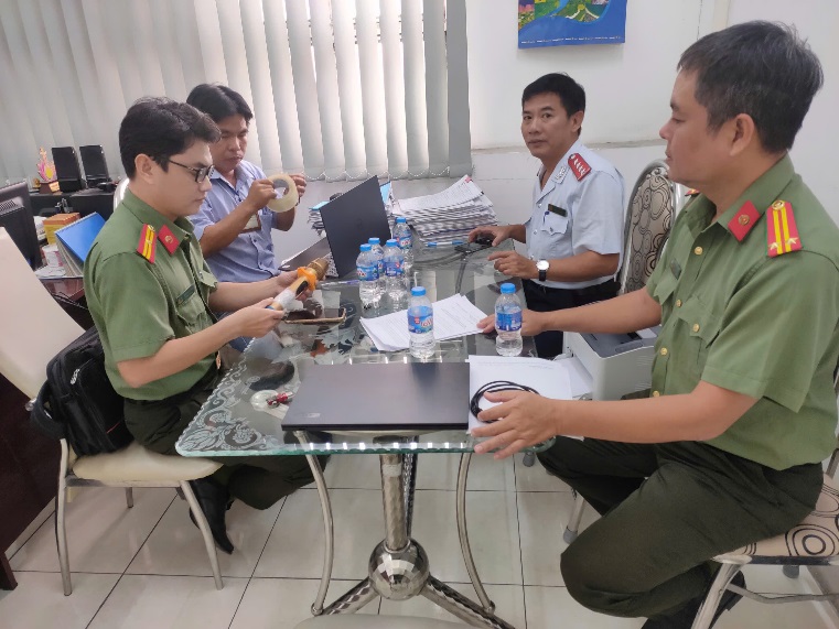 A group of men sitting around a table
Description automatically generated